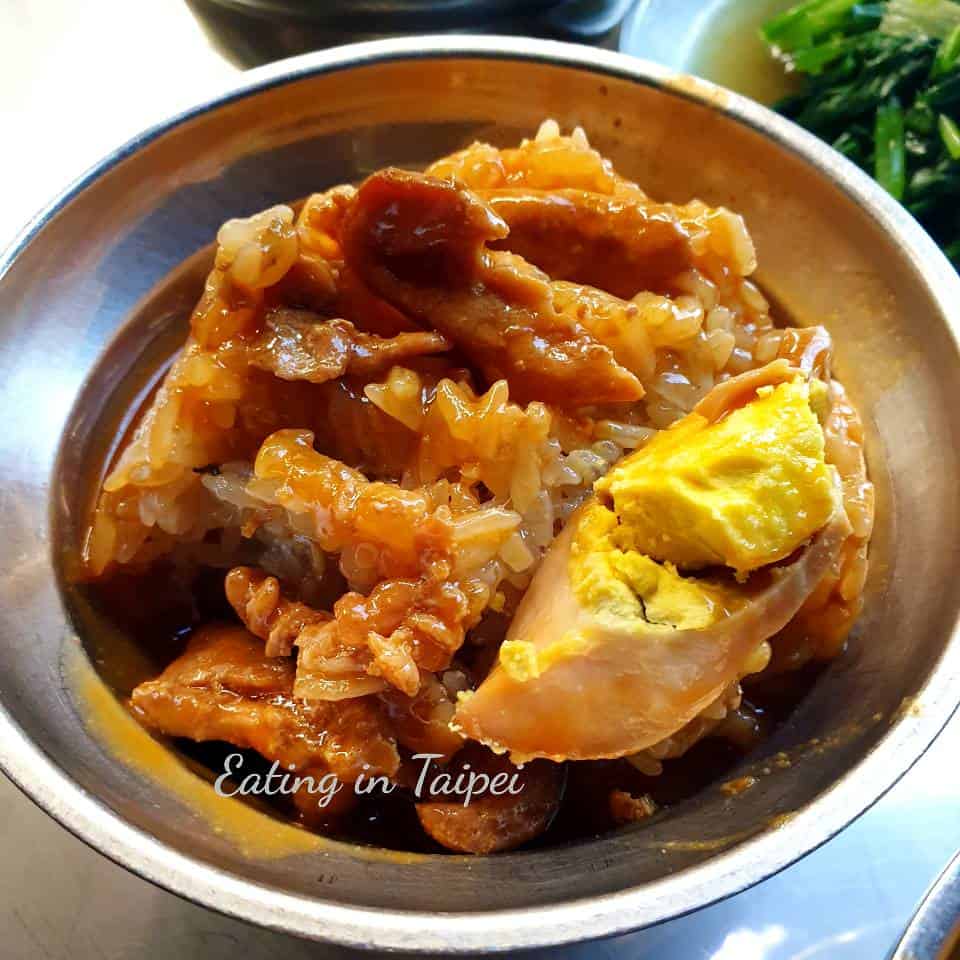 Tube-shaped sticky rice broken apart and doused in sauce