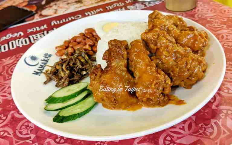 4 deep fried chicken drumsticks come doused in sauce, dressed with rice, chilli, dried fish, peanuts, a hard boiled egg, and some cucumber slices
